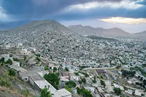 Homes Prints: View of Kabul's landscape from an overlook with a mix of urban and natural features at sunset