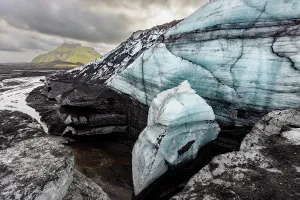 Glacier Prints: View of Katla glacier with blue ice and volcanic ash in Iceland surrounded by mountains