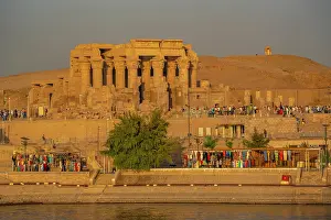 Nubia Prints: View of Kom Ombo Temple on the Nile river from cruise boat at sunset