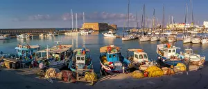 Fishermen Prints: View of Koules Venetian Fortress and boats in Heraklion Port at sunset in Crete
