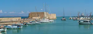 Docked Prints: View of Koules Venetian Fortress and harbor boats in Heraklion on a sunny day in Crete
