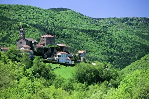 Roofs Prints: View of La Bastide-Pradines with green hills and trees during a sunny day in France's Occitanie region