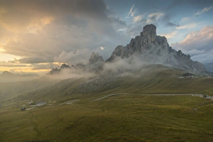 Winding Road Prints: View of landscape and winding road from Marmolada Pass at sunset