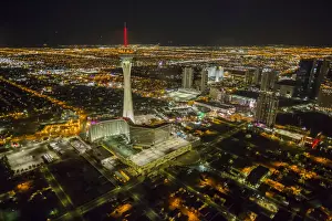 Typically American Prints: View of Las Vegas and Stratosphere Tower from helicopter at night, Las Vegas, Nevada