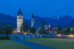 Tombstone Prints: View of Liebfrauenkirche and town and surounding mountains at dusk, Kitzbuhel, Austrian