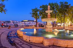 Locals Prints: View of Lisbon and fountain in Miradouro de Sao Pedro de Alcantara at dusk