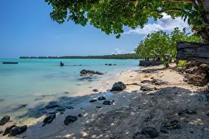 Fishing Rod Prints: View of man fishing from Mont Choisy Beach and turquoise Indian Ocean on sunny day