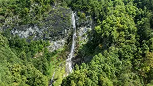 National Prints: View of Mesocco castle from above surrounded by lush green trees in the landscape of Switzerland