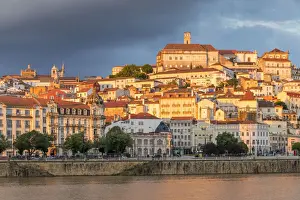 View from Mondego River to the old town with the university on top of the hill at sunset