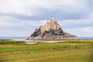 Flats Prints: View of Mont Saint-Michel Abbey from the tidal flats of Normandy during a cloudy day in Le Mont Saint Michel