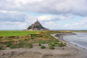 Marshes Prints: View of Mont Saint-Michel with fortified walls and abbey surrounded by salt marshes in Normandy of France
