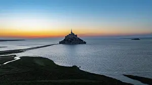 Atmosphere Prints: View of Mont St. Michel at dusk with the tidal waters reflecting the colors of the sky in France