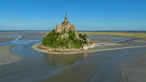 Drone Prints: View of Mont St. Michel surrounded by water at low tide in France showing the historic architecture
