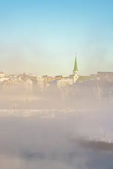 Lutheran Prints: View of morning mist in Tjornin park and Lutheran Free Church on a sunny day in winter
