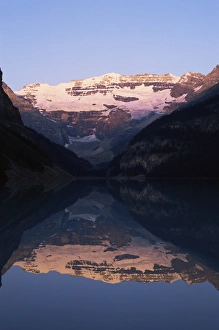 Mount Victoria Prints: View to Mount Victoria across the still waters of Lake Louise, at sunrise in summer