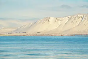 Temperatures Prints: View of mountainous coastline North of the city seen from Reykjavik in winter
