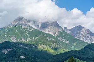 Tall Prints: View of mountains and clouds near Saalfelden on a sunny day in Salzburg region, Austria
