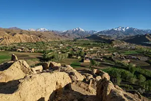 Dirt Prints: View of mountains surrounding Bamyian with fields and villages from ancient site of Shahr-e-Gholghola in Afghanistan