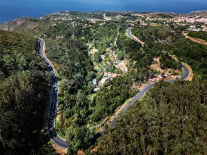 Highway Prints: View of N247 highway winding through green hills near coastal area in Portugal during sunny weather