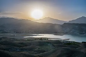 Season Prints: View of Naghlu lake during sunset in eastern Afghanistan with mountains in the background