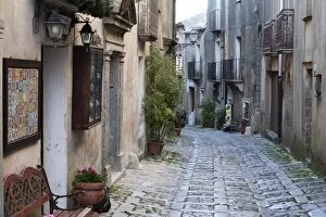 View down narrow cobbled street, Erice, Sicily, Italy, Europe