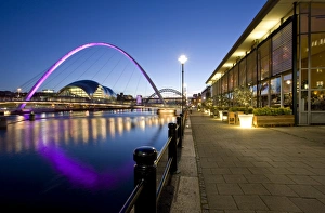 View along Newcastle Quayside at night showing the River Tyne, the floodlit Gateshead Millennium Bridge, the Arched Bridge and the Sage Gateshead, Newcastle-upon-Tyne, Tyne and Wear, England, United View along Newcastle Quayside at night showing the River Tyne, the floodlit Gateshead Millennium Bridge, the Arched Bridge and the Sage Gateshead, Newcastle-upon-Tyne, Tyne and Wear, England, United