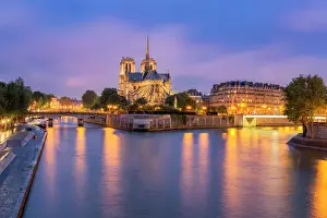 Glowing Prints: View of Notre Dame de Paris and its flying buttresses across the River Seine at blue hour