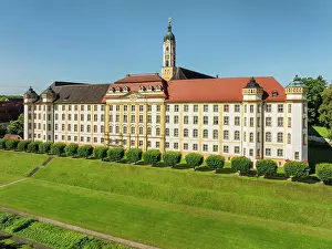Lawn Prints: View of Ochsenhausen Monastery in Upper Swabia during a clear day with blue sky and green lawn