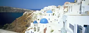 View of Oia with blue domed churches and whitewashed buildings