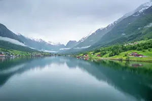 Fjord Prints: View of Olden village and mountains reflecting in Nordfjorden during summer