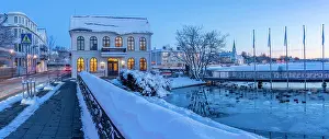 Chill Prints: View of ornate buildings of Reykjavik from Tjornin lake at dusk in winter