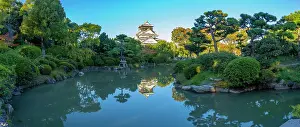 Chuo Prints: View of Osaka Castle (Osaka-jo) reflecting in Japanese garden pond at sunset
