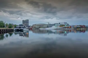 Public Space Prints: View of Oslo Opera House and Munch Museum reflecting in harbour on cloudy day