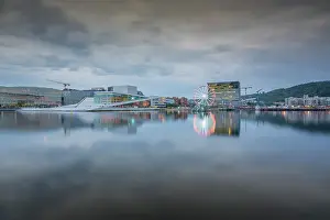 Ferris Wheel Prints: View of Oslo Opera House and Munch Museum reflecting in harbour on cloudy day