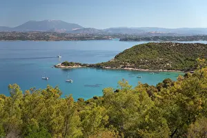 Azure Prints: View over Paralia Zogerias beach with crystal clear blue water in bay and anchored yachts