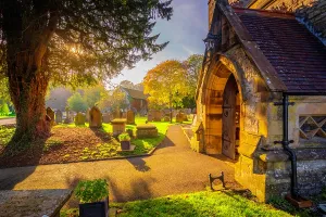 Cemetery Prints: View of Parish Church in Ashford surrounded by water and autumn colors in Derbyshire