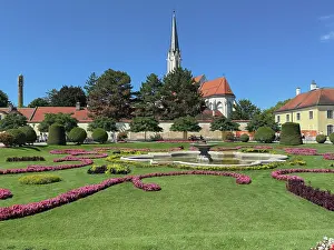 Lawn Prints: View of parish church and gardens in Hietzing from Schonbrunn Gardens in Vienna during sunny weather in summer