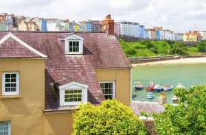 Pembrokeshire Prints: View of pastel colored buildings and harbor in Tenby