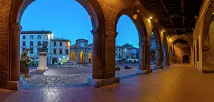 Portico Prints: View of Piazza Cavour from arches of Palazzo del Podesta in Rimini at dusk
