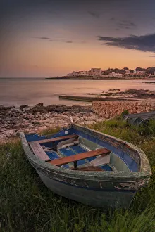 Menorca Prints: View of Playa Punta Prima and rowing boat at dusk