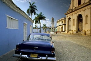 Plaza Mayor Prints: View across Plaza Mayor with old American car parked on cobbles, Trinidad