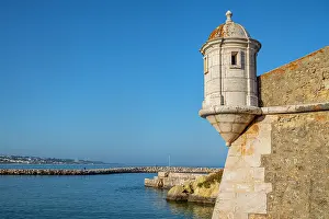 Maritime Prints: View of Ponta da Bandeira fort structure in Lagos with blue sky and coastal scenery in Portugal