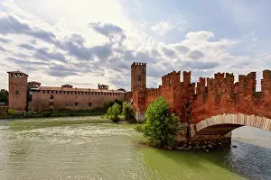 Verona Prints: View of Ponte Scaligero and Castelvecchio castle over River Adige in Verona with a cloudy sky
