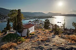Chapel Prints: View over Poros town with Greek Orthodox chapel at sunset