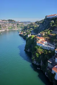 Riverside Prints: View of Porto with Ponte da Arrabida over Douro River in Portugal on a clear day