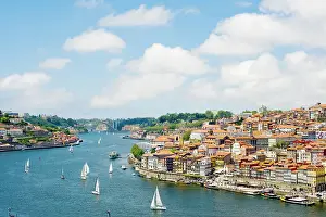 Waterfront Dining Prints: A view of Porto's historic centre and the Duoro River flowing towards its estuary and the Atlantic Ocean