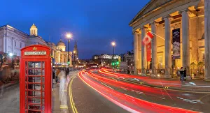 Telephone Box Prints: View of red telephone box and Trafalgar Square at dusk