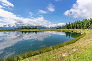 Wetlands Prints: View of reflection of mountains and clouds in Plettsaukopf Reservoir on a sunny day