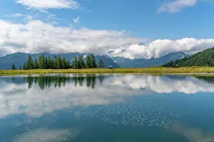 Reservoir Prints: View of reflection of mountains and clouds in Plettsaukopf Reservoir on a sunny day