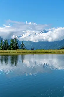 Forestry Prints: View of reflection of mountains and clouds in Plettsaukopf Reservoir on a sunny day